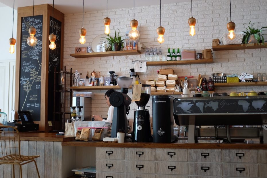 black kitchen appliance on kitchen island with pendant lights