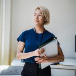 Portrait of Woman in Office Holding Files
