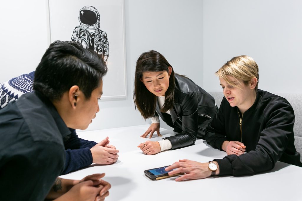 people in a meeting in a white room discussing app development