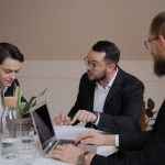 Man in Black Suit Jacket Using Macbook