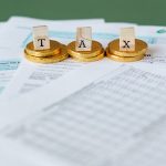 Gold Coins on Top of Documents