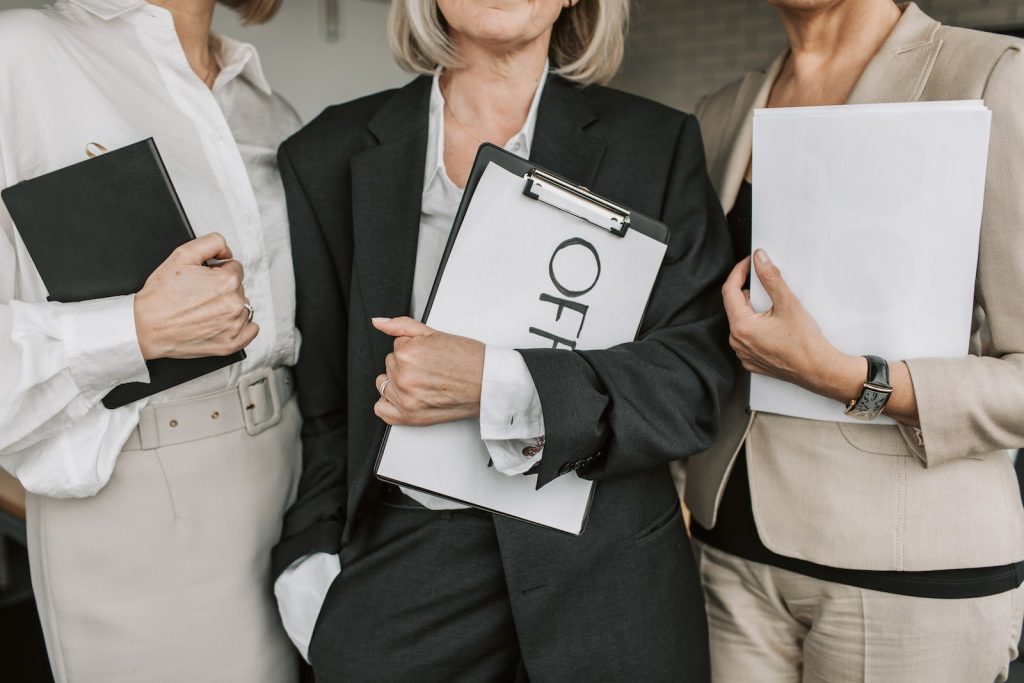 Close-Up Shot of Businesswomen Holding Documents