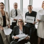 People in Business Attire Holding Papers