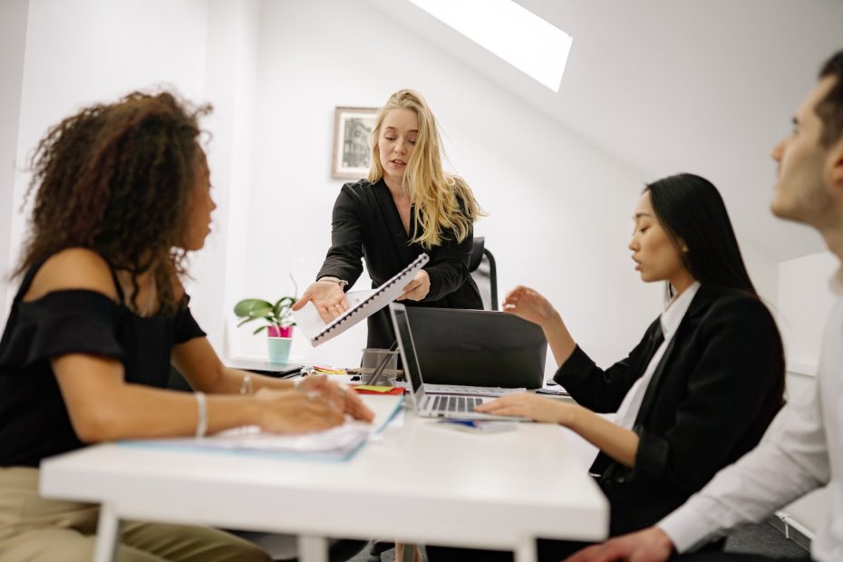 Woman in Black Blazer Using Macbook
