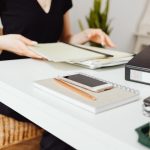Woman in Black Long Sleeve Shirt Sitting at the Table