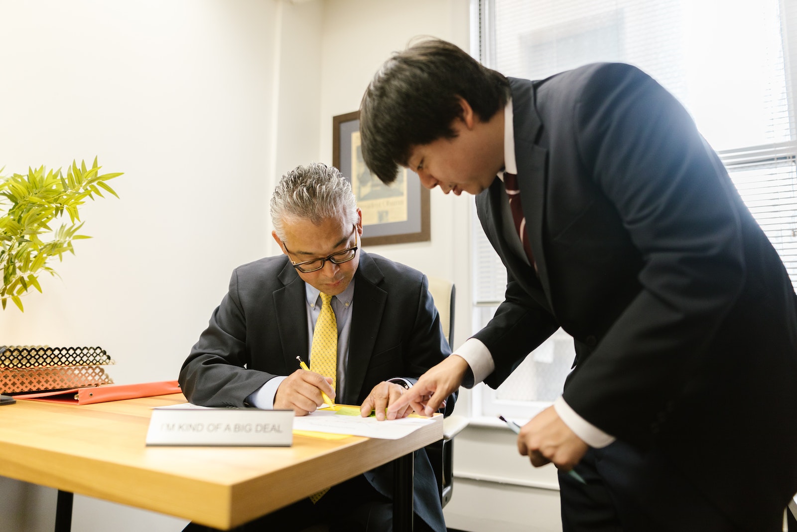 A Man Showing his Boss a Document