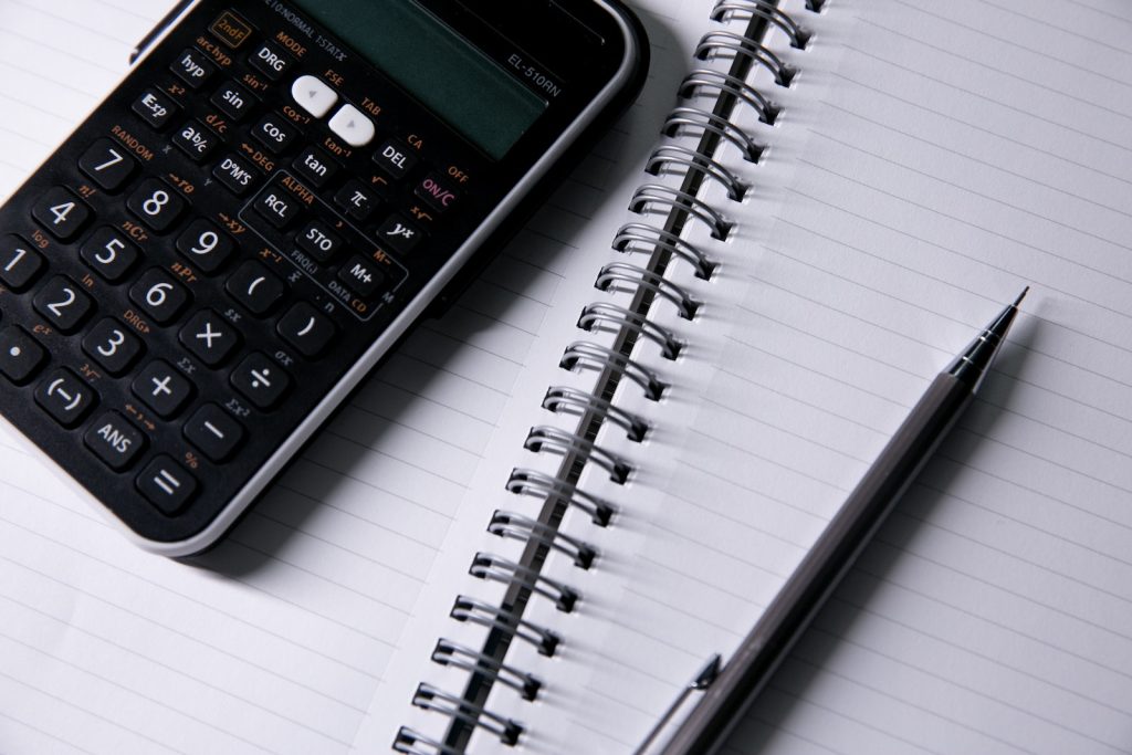 Black Calculator on White Spiral Notebook