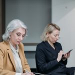 Woman in Black Blazer Holding Smartphone