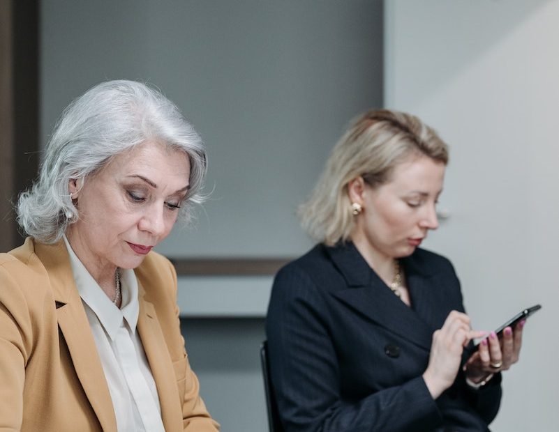 Woman in Black Blazer Holding Smartphone