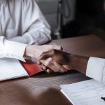 Vermont LLC Operating Agreement: What You Need To Know Unrecognizable Hands Handshaking over Table