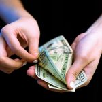 How Much Does It Cost to Start an LLC in Ohio: Ohio LLC Annual Fees person holding fan of 100 us dollar bill