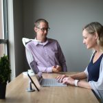 man and woman sitting at table